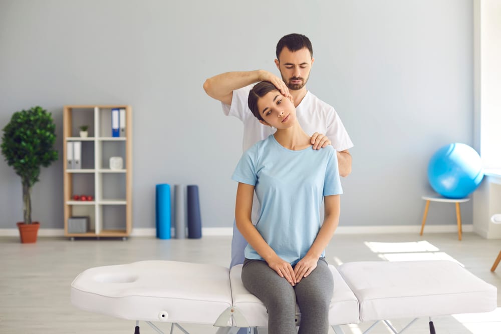 Chiropractor Adjusting A Womans Neck