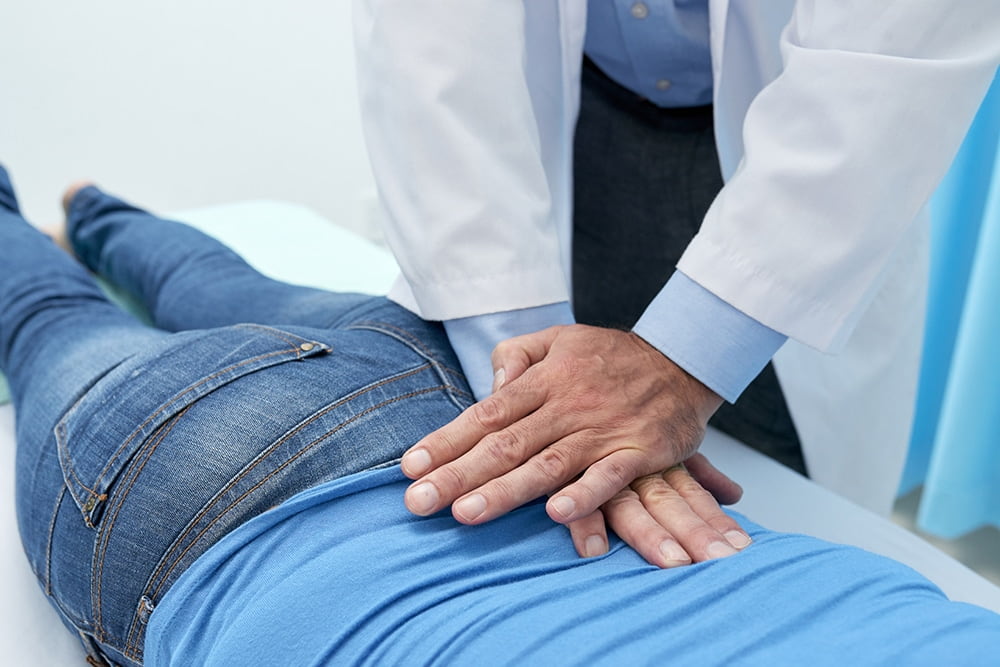 Doctor Massaging A Patients Lower Back