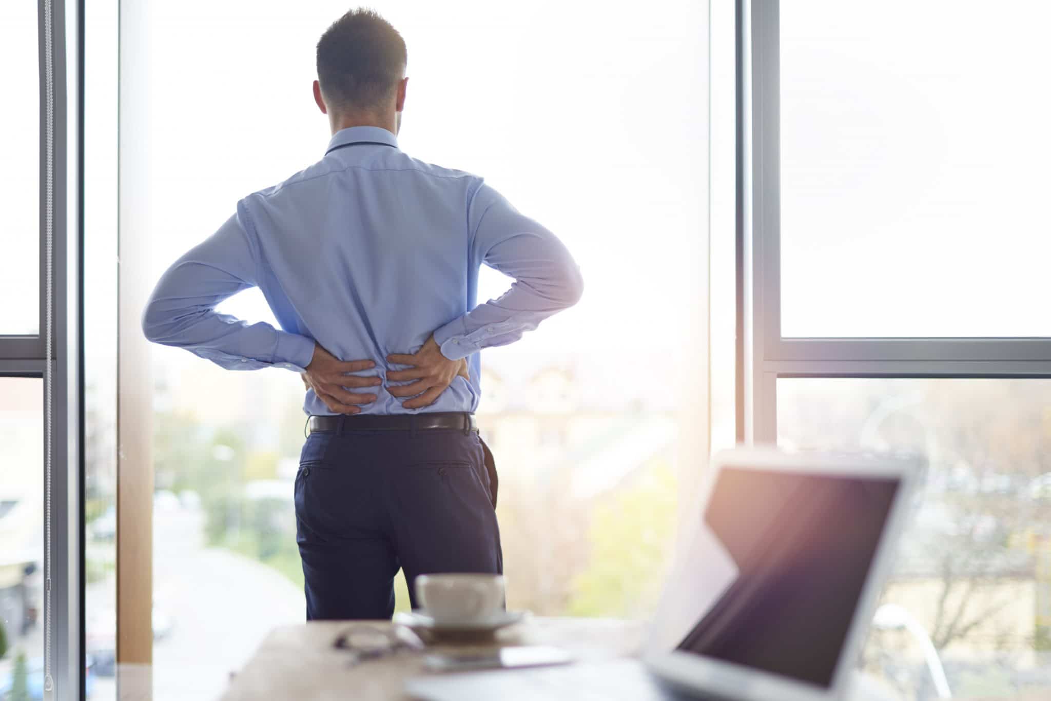 Business Person Holding His Back In Pain