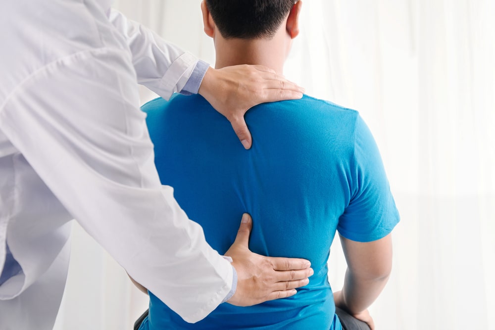 Doctor Examining A Patients Back