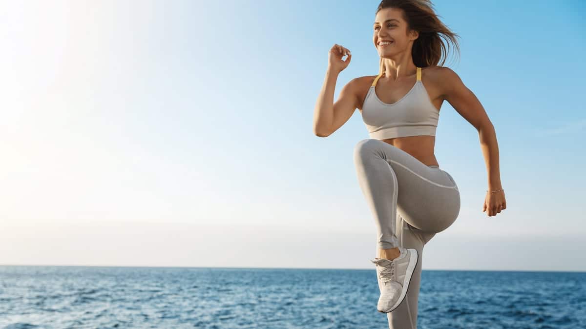 Energised Woman Doing Sports At The Beach
