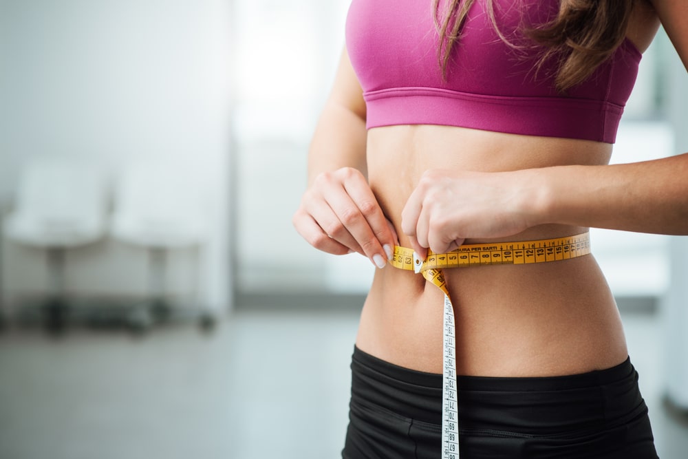 Woman Measuring Her Belly Circumference