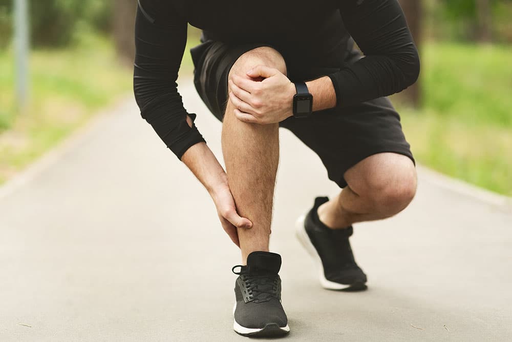 Male Runner Is Suffering From Ankle Pain