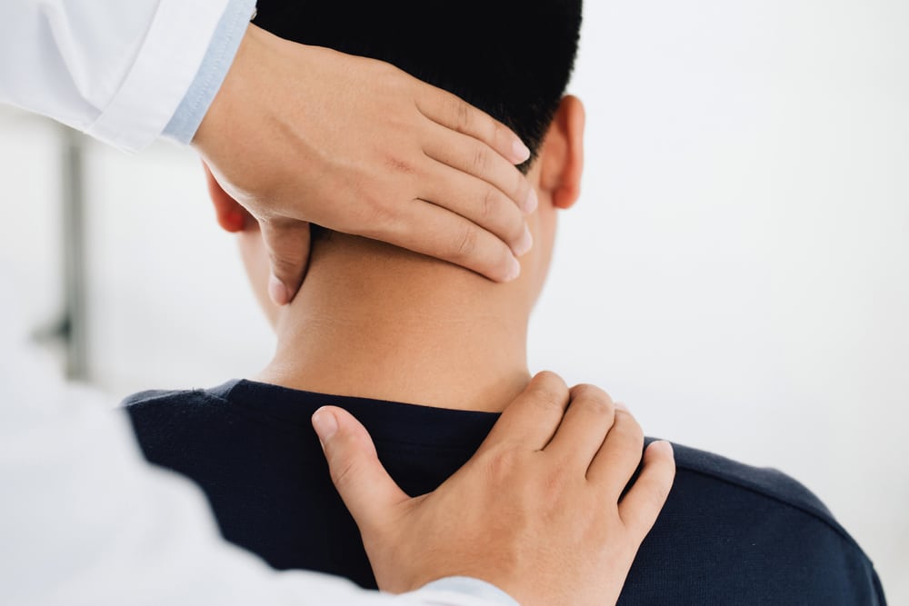Chiropractor Performing A Neck Massage On A Client