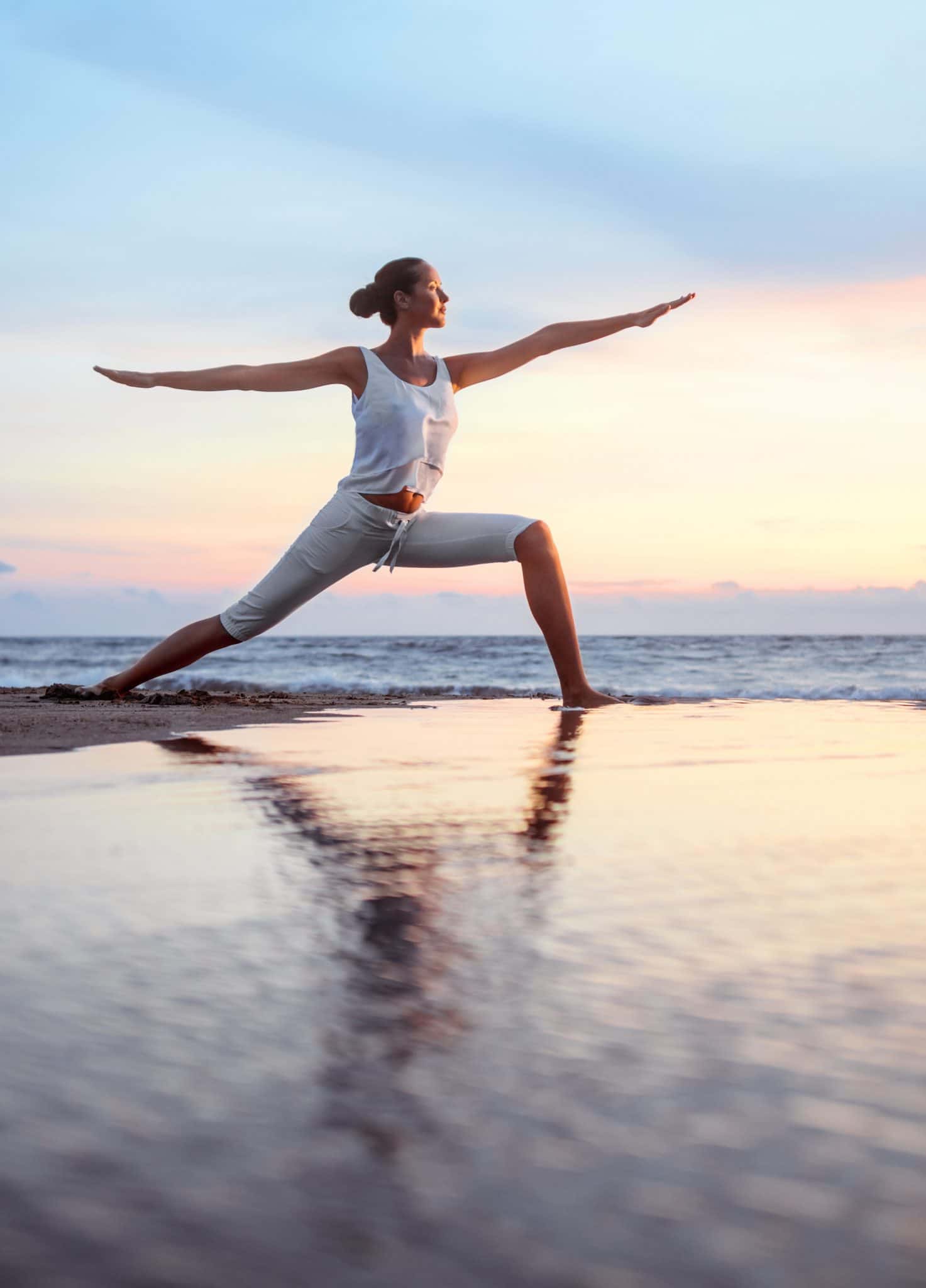 Woman Doing Yoga On A Beach