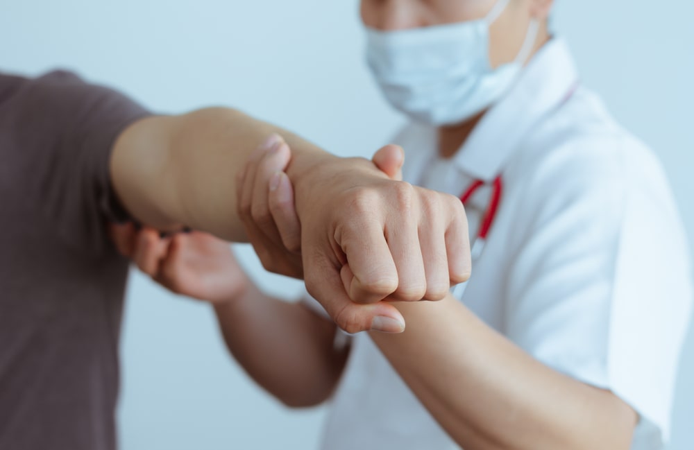 Doctor Examining A Patients Arm