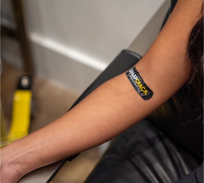 Woman With A SnapCrack Bandage On Her Arm